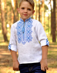 White linen boys’ vyshyvanka with volumetric blue embroidery and transformable sleeves