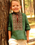 Green linen boys’ vyshyvanka with brown geometric embroidery and sleeves styled as 3/4