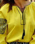 Yellow women’s vyshyvanka with geometric ornament inspired by the Ukrainian flag