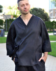 Close-up of men’s black linen kimono set with black embroidery on the wrap neckline