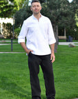 White Ukrainian-style men’s vyshyvanka styled with optional black linen trousers