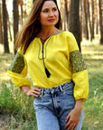 Yellow women’s vyshyvanka with geometric ornament inspired by the Ukrainian flag
