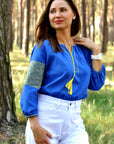 Blue linen women’s vyshyvanka with yellow patriotic embroidery and hidden Trident motif