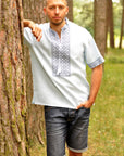 Light embroidered men`s shirt with short sleeve