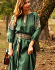 Dark green linen dress with feminine silhouette and traditional ornament