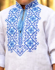 White boys’ Ukrainian-style embroidered shirt with long sleeves styled as 3/4 sleeves