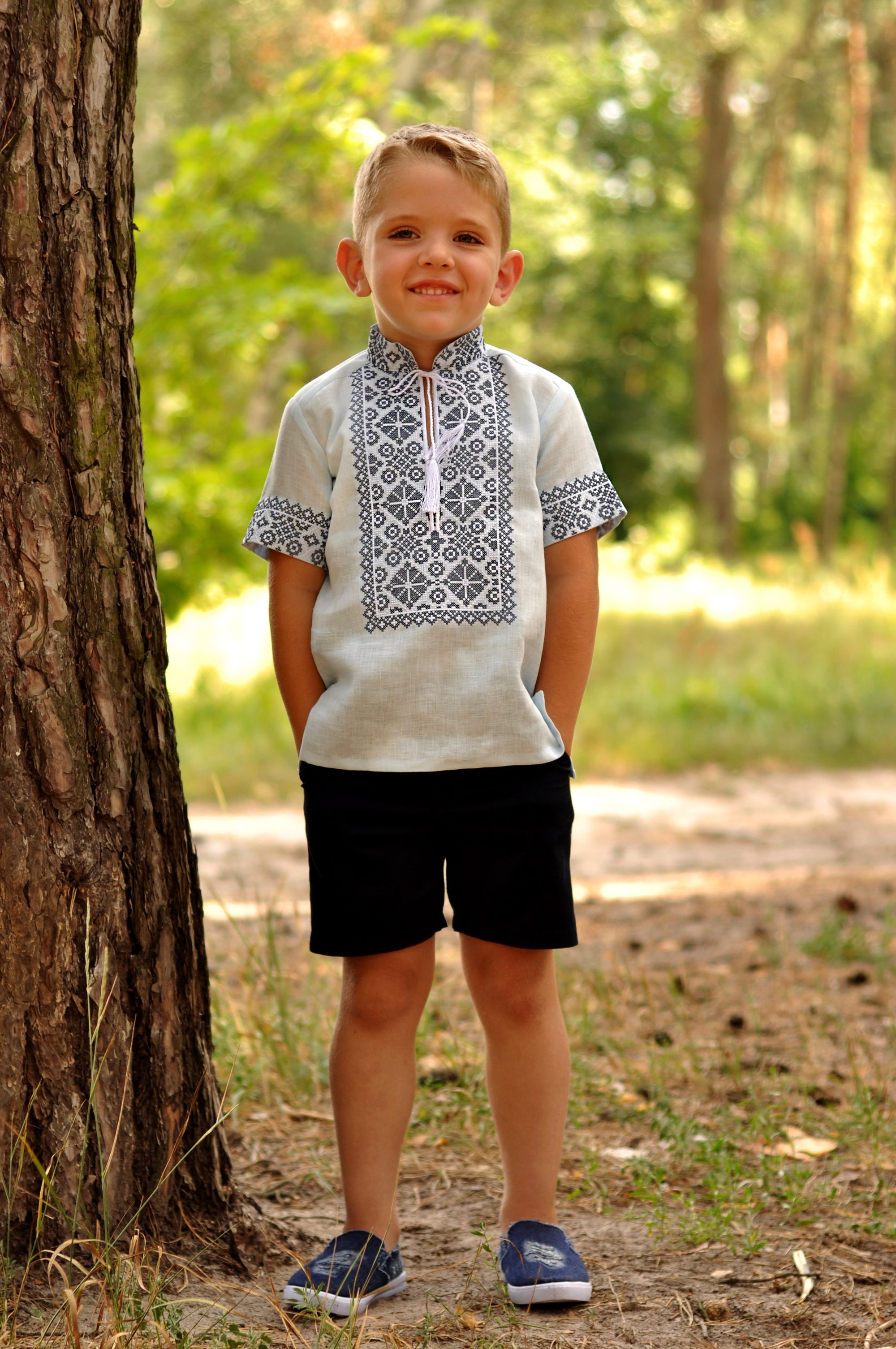 Boys’ light blue embroidered linen shirt with stand collar and traditional ornament