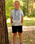 Boys’ light blue embroidered linen shirt with stand collar and traditional ornament