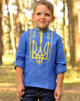 Blue linen boys’ vyshyvanka with yellow Trident embroidery and sleeves styled as 3/4