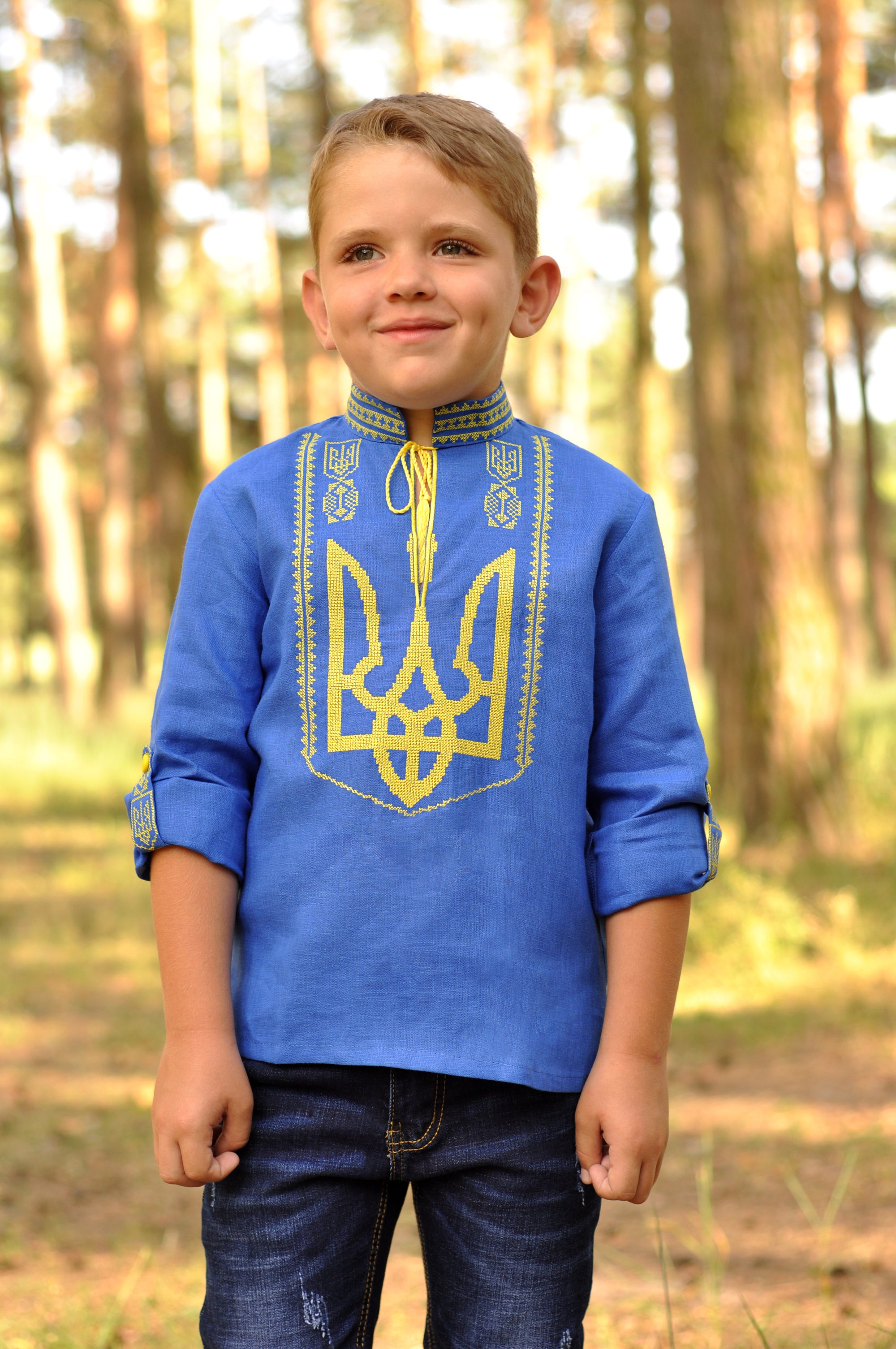 Blue boys’ Ukrainian-style embroidered shirt with long sleeves and yellow Trident design