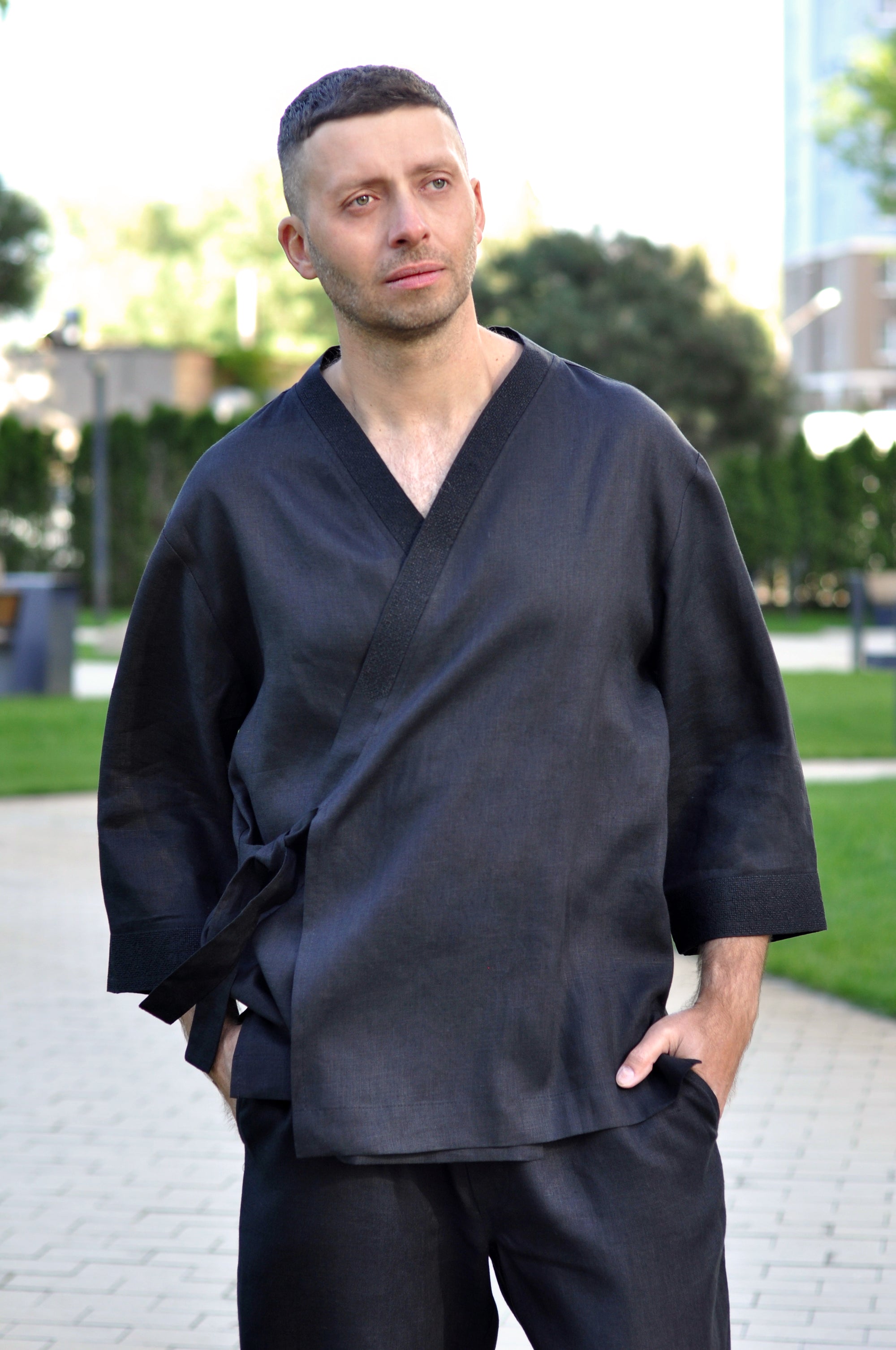 Close-up of men’s black linen kimono set with black embroidery on the wrap neckline
