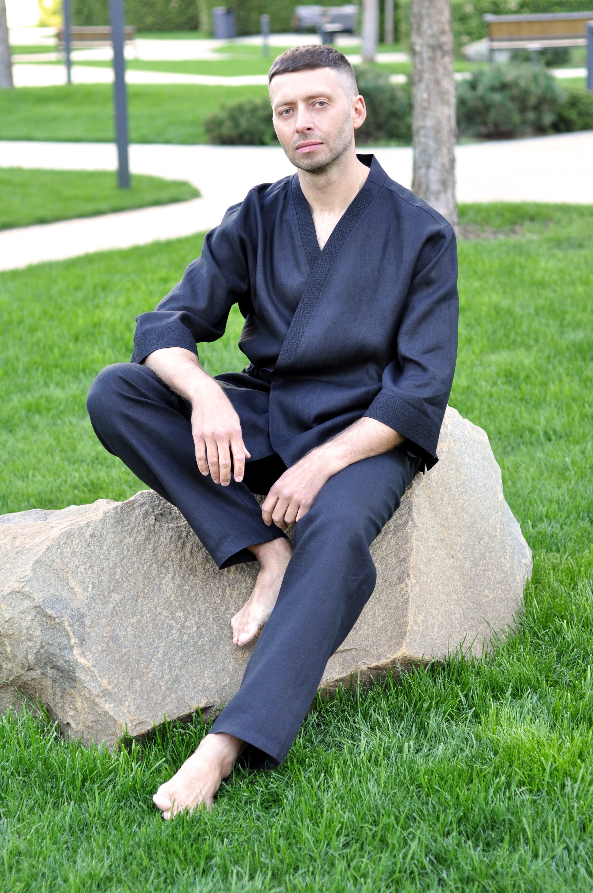 Full-length view of a men’s black linen two-piece set with kimono top and loose pants