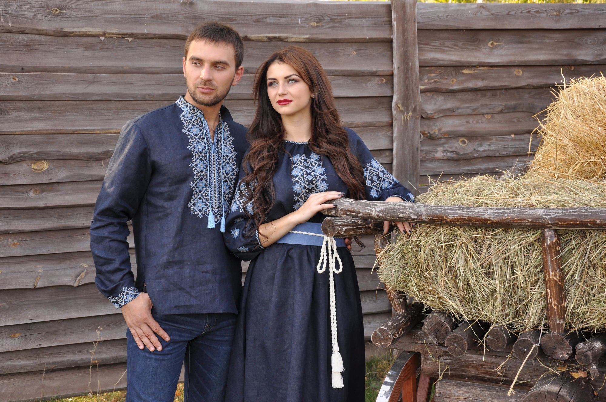 Women’s navy embroidered maxi dress with solid-color belt and men emroidered shirt
