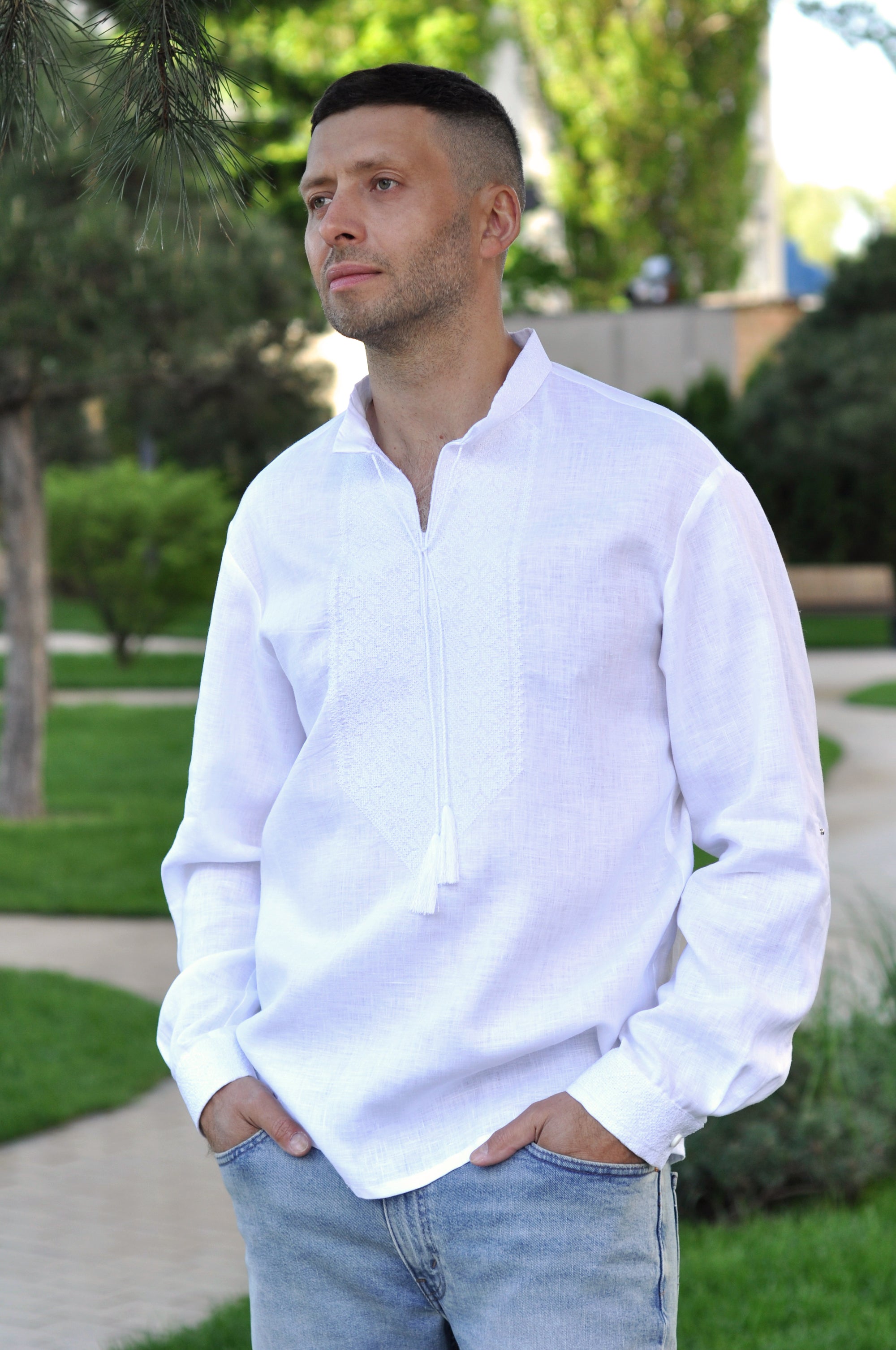 Close-up of white-on-white geometric embroidery on a men’s linen shirt