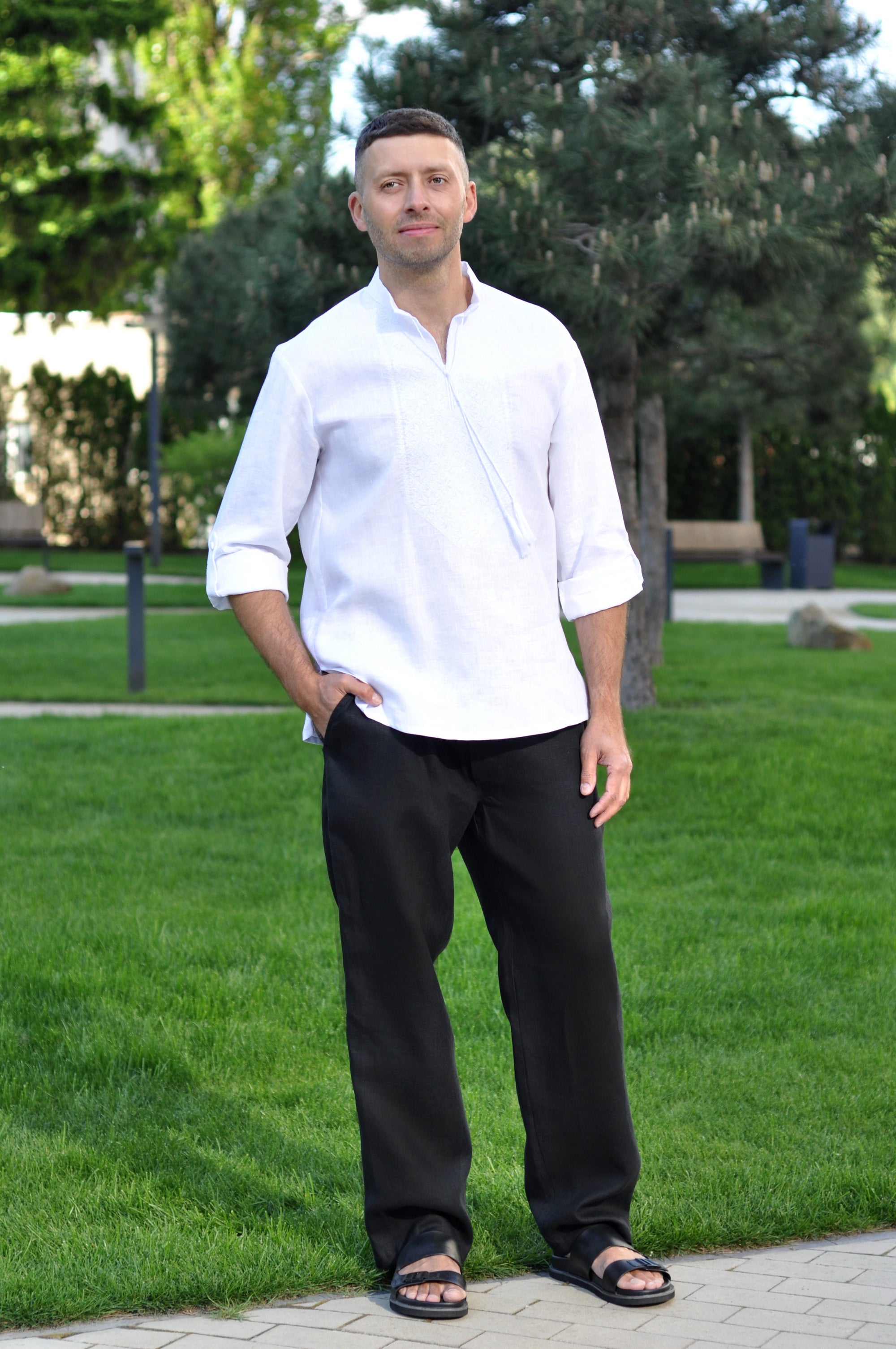 White Ukrainian-style men’s vyshyvanka styled with optional black linen trousers