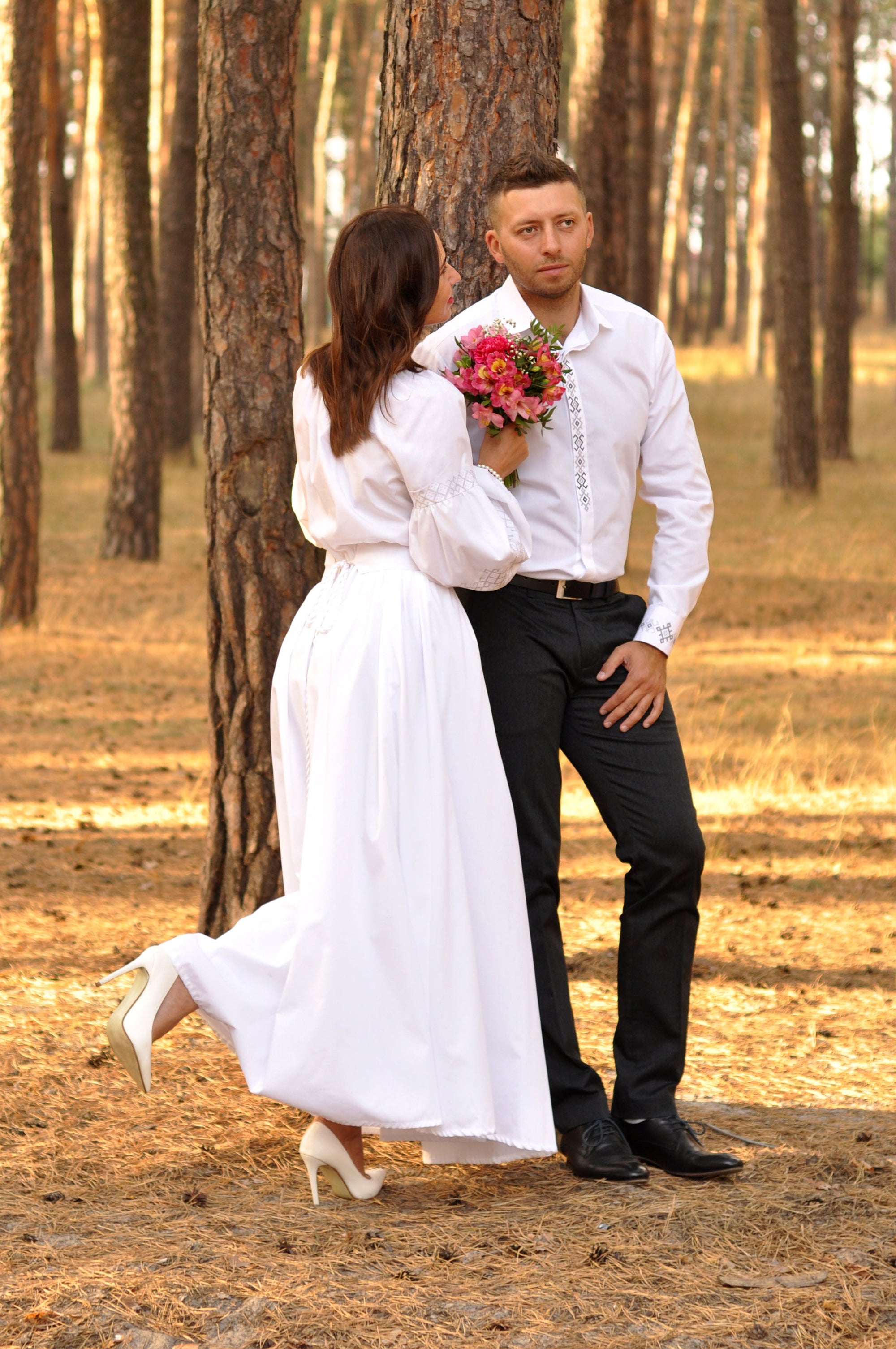 Women’s white embroidered dress with long sleeves for a wedding ceremony