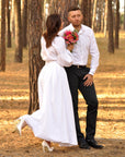 Women’s white embroidered dress with long sleeves for a wedding ceremony