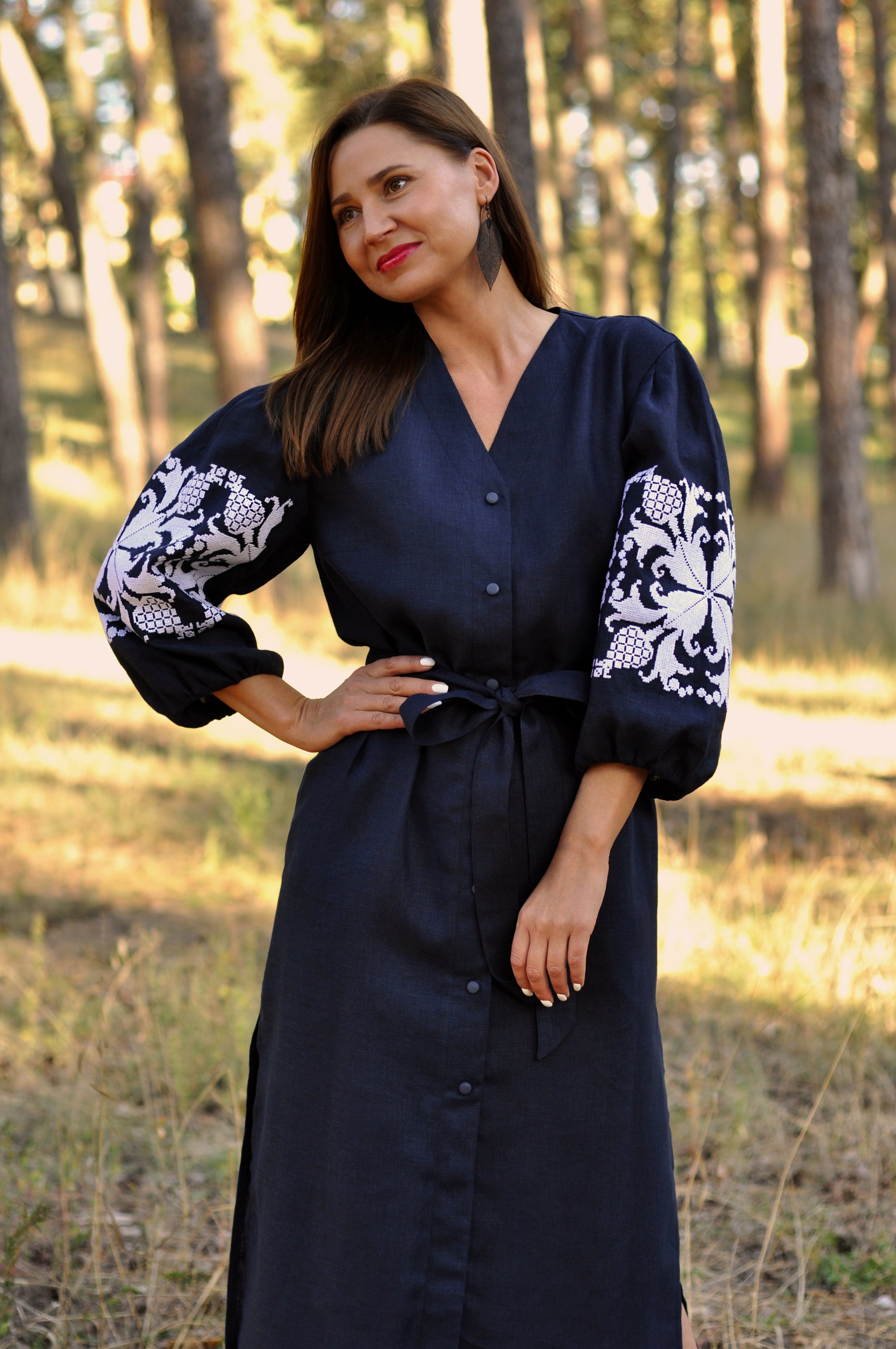 Dark blue linen dress with feminine silhouette and symbolic rose motif