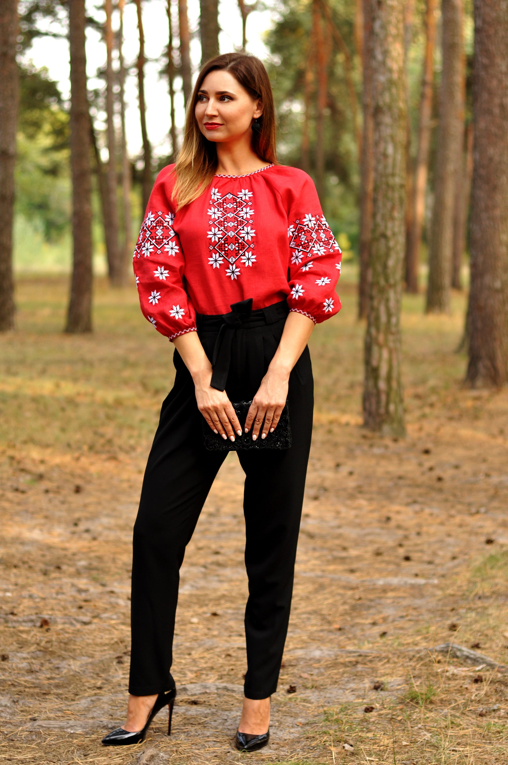 Women’s red embroidered blouse in natural linen styled with black trousers