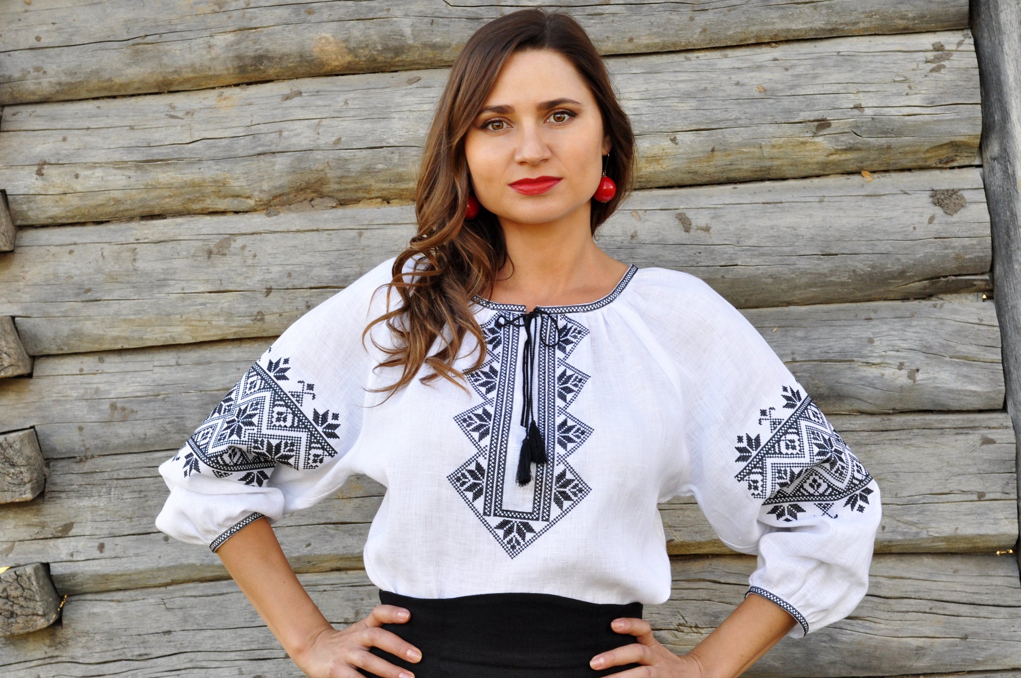 Women’s white embroidered blouse with black ornament and tassel ties