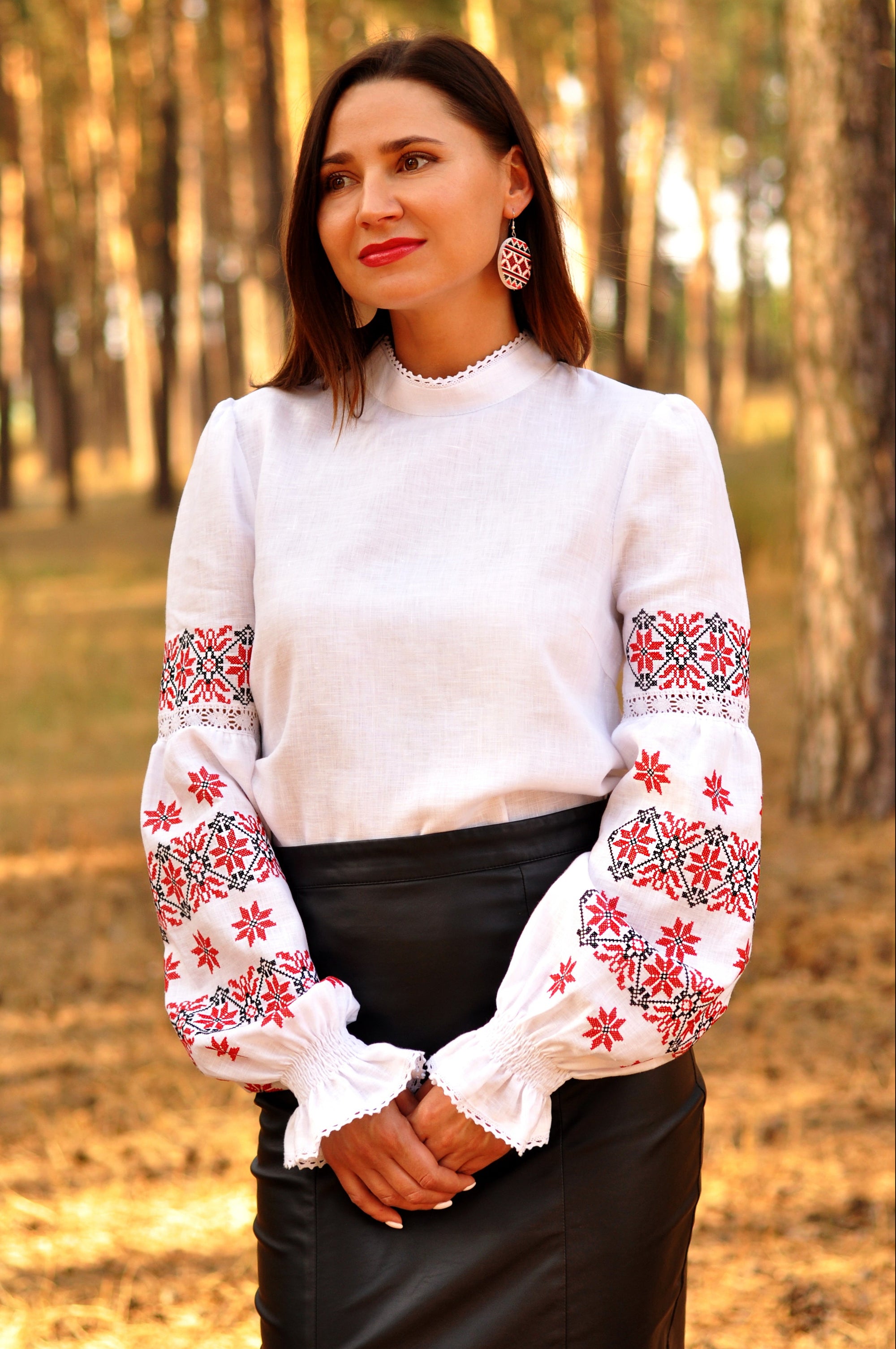 White linen women’s vyshyvanka with red and black embroidery and lace sleeve inserts