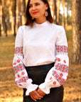 White linen women’s vyshyvanka with red and black embroidery and lace sleeve inserts