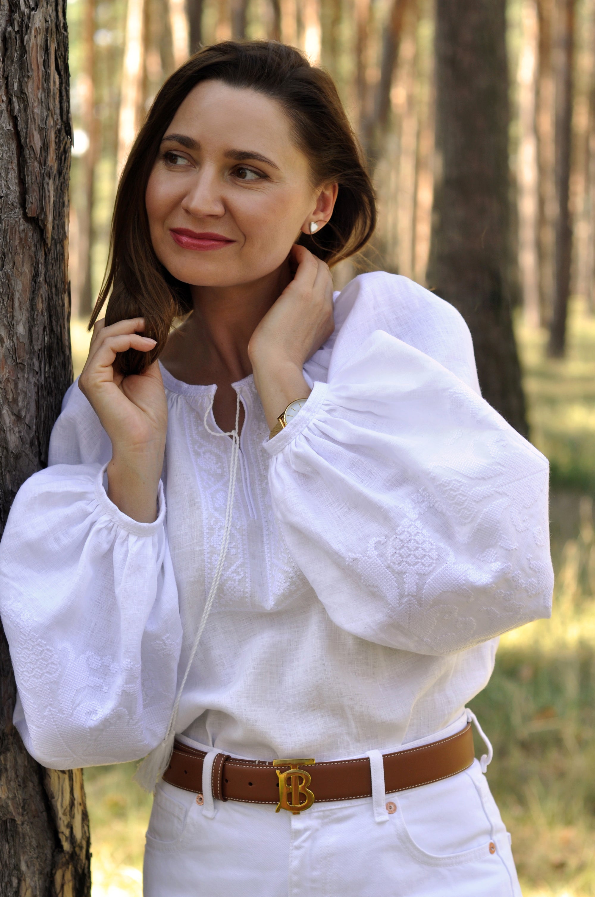 Women’s white embroidered blouse with long sleeves and monochrome ornament
