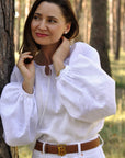 Women’s white embroidered blouse with long sleeves and monochrome ornament