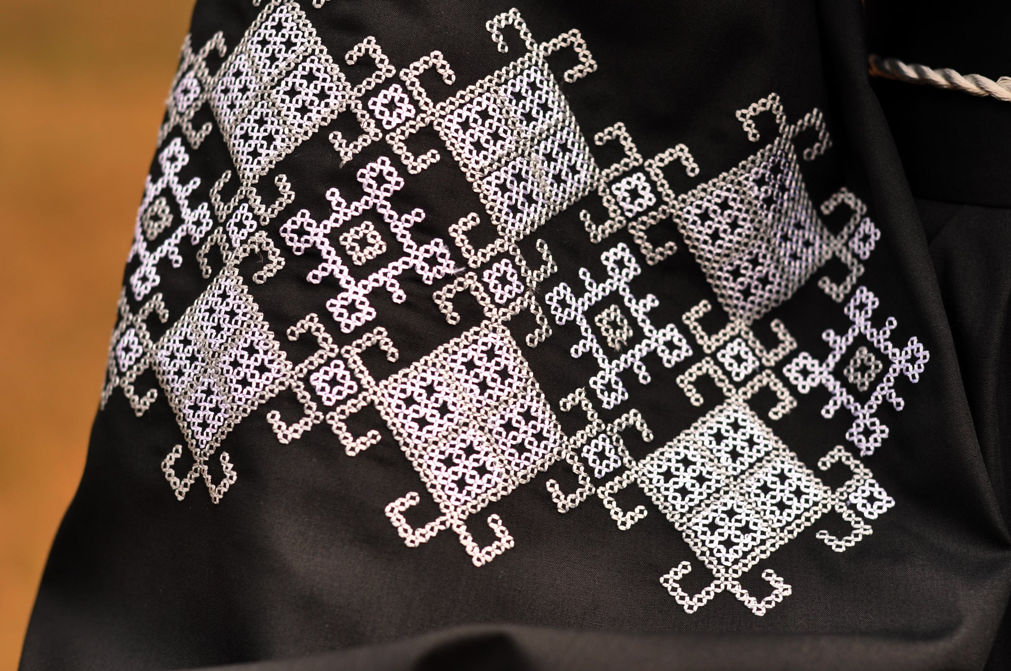 Black evening dress with refined white and gray ornament