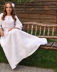 Elegant bridal dress in natural linen with gray-white ornament
