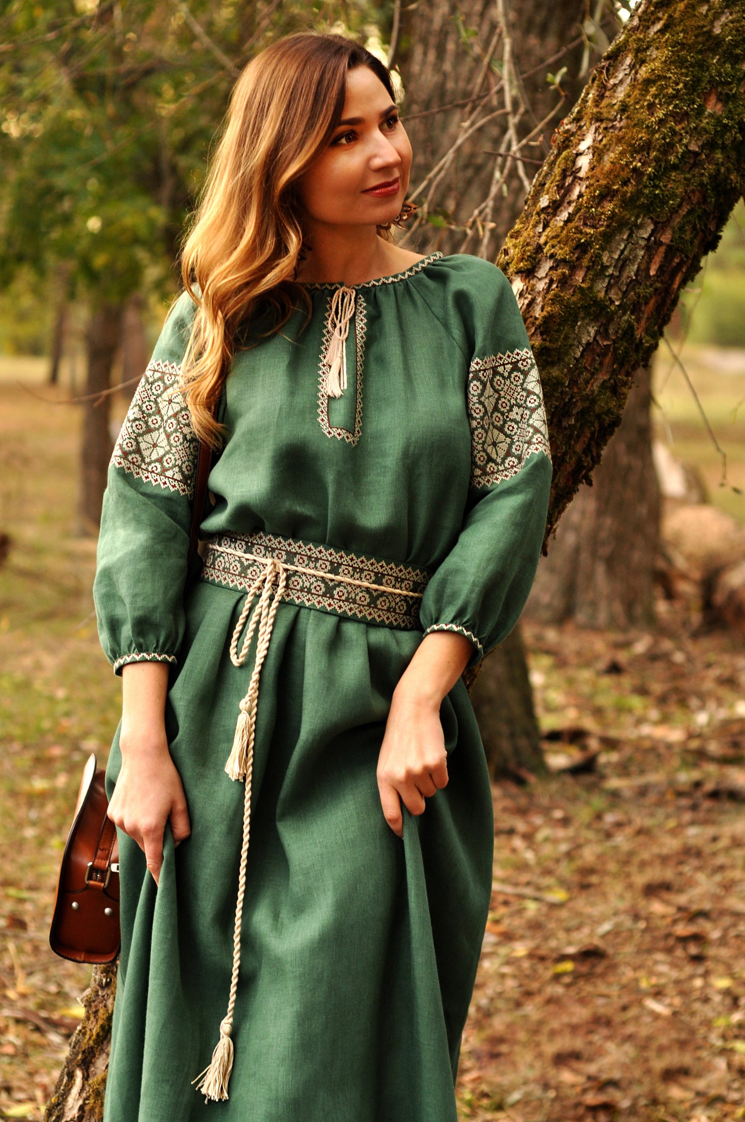 Dark green linen dress with feminine silhouette and traditional ornament