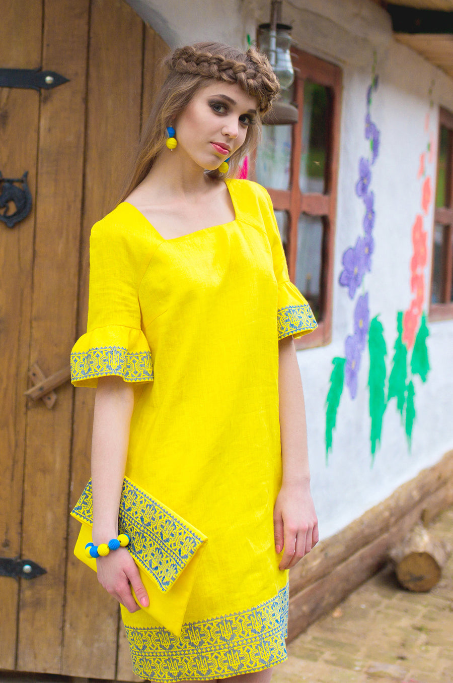 The dress is yellow with embroidery in the national style
