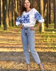 Elegant white linen blouse with blue floral Ukrainian-style embroidery
