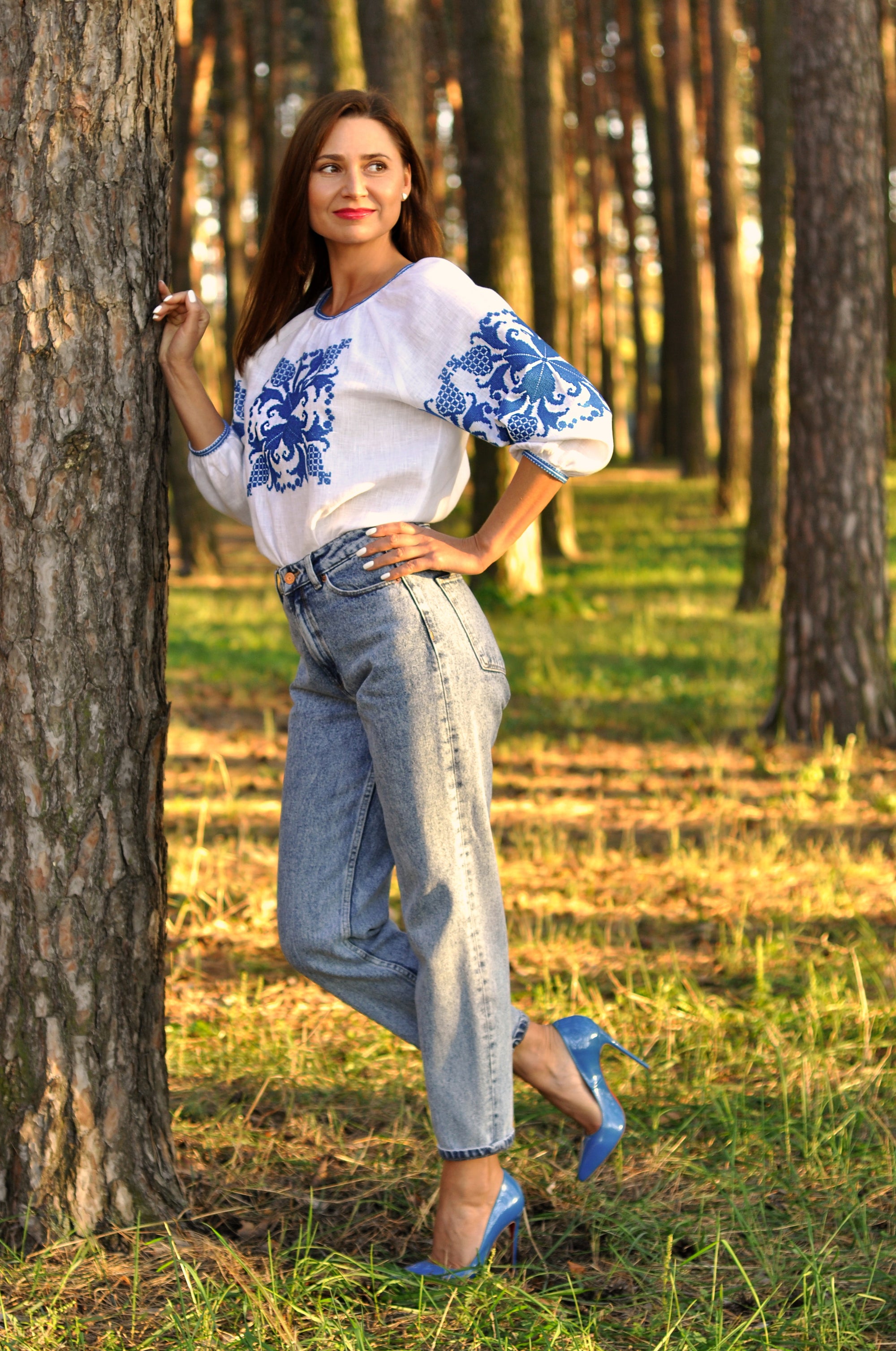 Women’s white embroidered blouse with 3/4 sleeves and dimensional blue ornament